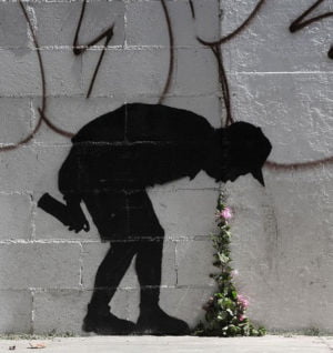 Grafitti eines sich übergebenden Mannes